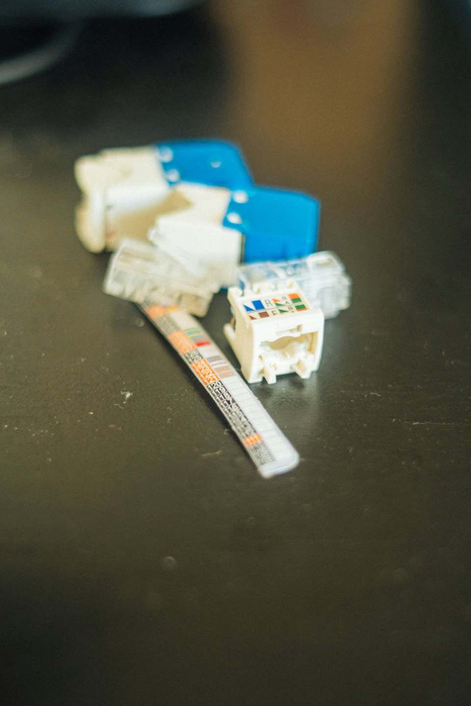 Network cabling components including RJ45 connectors and a keystone jack.